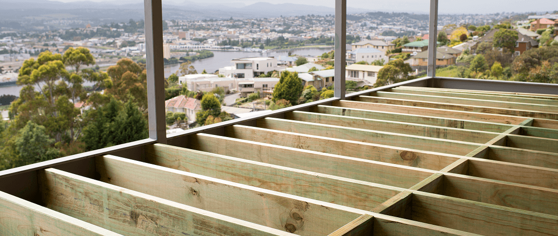 Timberlink Green framing in a deck with houses in background